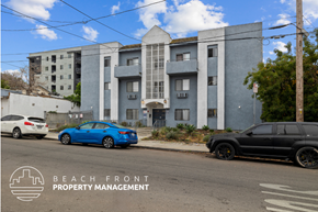 Los Angeles apartment for rent - a large apartment building with cars parked in front of it
