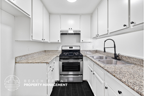 Los Angeles apartment for rent - A kitchen with white cabinets and a granite countertop.