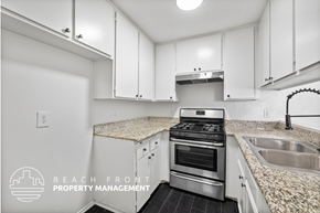 Los Angeles apartment for rent - A kitchen with white cabinets and a granite countertop.