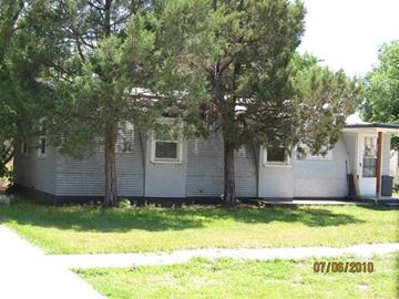 Scottsbluff house for rent - a white house with trees in front of it