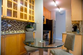 Chicago apartment for rent - A kitchen with a glass table and chairs.