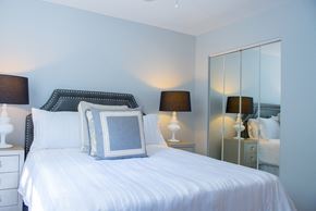 Chicago apartment for rent - A bedroom with a bed, nightstand, and two lamps.
