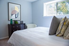 Chicago apartment for rent - A bedroom with a bed, nightstand, and a painting on the wall.