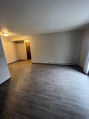 Moorhead apartment for rent - A room with a wooden floor and a door.