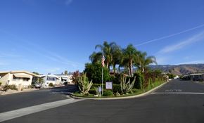 Highland apartment for rent - a street with houses and palm trees and an flag