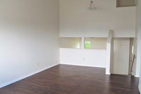 Brandon townhouse for rent - an empty living room with wood floors and white walls