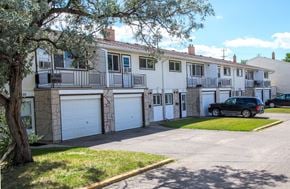 Brandon townhouse for rent - a white apartment building with a car parked in the driveway