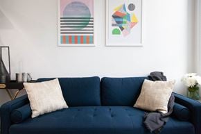 Brooklyn apartment for rent - A blue couch with two pillows and a blanket on it.