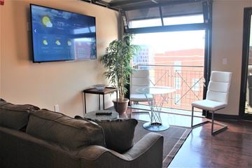 Lincoln apartment for rent - a living room with a couch and a tv on the wall