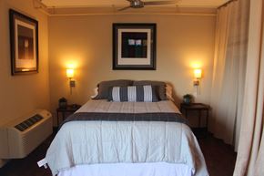 Lincoln apartment for rent - the master bedroom has a large bed and a window