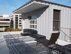 Lincoln apartment for rent - a roof terrace with two chairs and a balcony with a building in the background