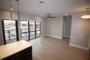 Lincoln apartment for rent - a kitchen and living room with a balcony and a ceiling fan