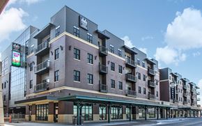 Lincoln apartment for rent - a rendering of a brick apartment building on a city street