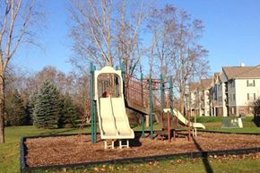 Grand Blanc apartment for rent - a child playing on a slide on a playground