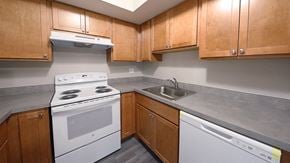 Bethlehem apartment for rent - a kitchen with white appliances and wooden cabinets