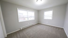 Bethlehem apartment for rent - an empty bedroom with two windows and carpeting