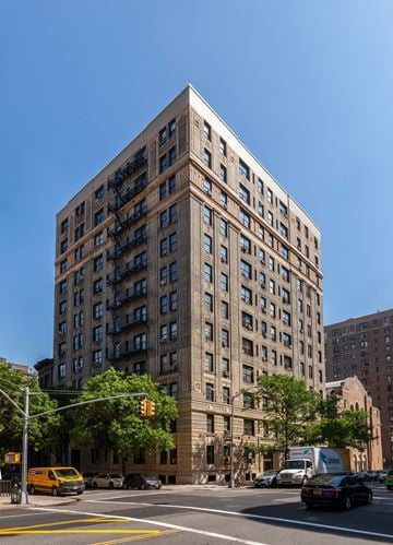 Manhattan apartment for rent - a tall building with many windows on a city street