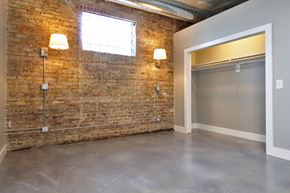 Oak Park apartment for rent - an empty room with a brick wall and a garage door