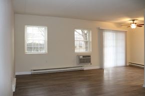 Lancaster apartment for rent - an empty living room with a ceiling fan and a window