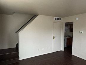 Dayton apartment for rent - A room with a staircase and a door leading to a kitchen.
