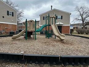 Dayton apartment for rent - A playground with a green slide and a tan slide.