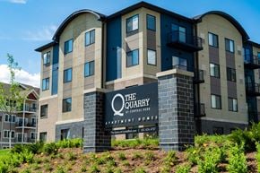 Eagan apartment for rent - a large apartment building with a sign for the quality apartments at anthem towers