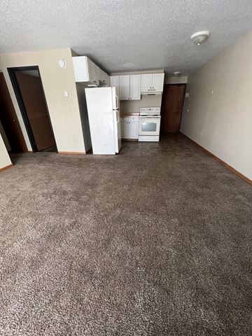 Moorhead apartment for rent - A kitchen area with a white fridge, stove and oven.