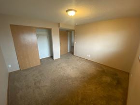 Fargo apartment for rent - A room with a carpeted floor and a ceiling light.