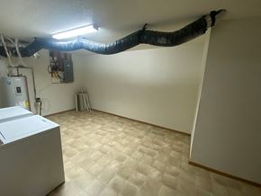 Fargo apartment for rent - A room with a white wall and a black pipe running along the ceiling.