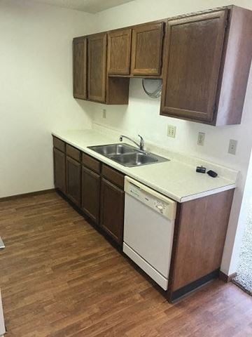 Fargo apartment for rent - A kitchen with wooden cabinets and a white dishwasher.