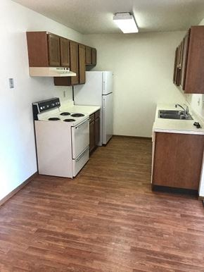 Fargo apartment for rent - A kitchen with a stove, refrigerator, and sink.