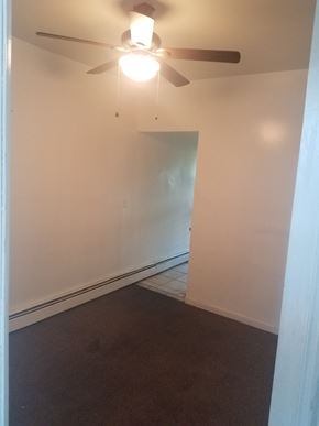 Paterson apartment for rent - A room with a ceiling fan and a door.