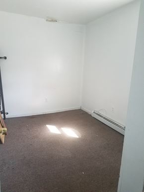 Paterson apartment for rent - A room with a carpeted floor and a window letting in sunlight.
