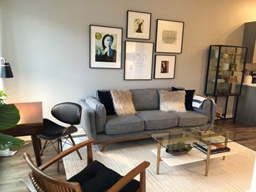 Saint Louis apartment for rent - a living room with a gray couch and a glass coffee table