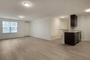 Toms River apartment for rent - an empty living room with a kitchen and a window