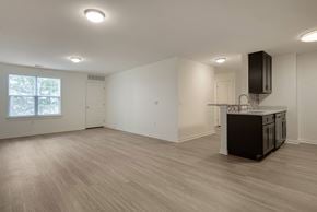 Toms River apartment for rent - an empty living room with a kitchen and a window