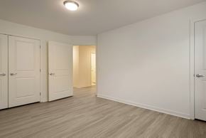 Toms River apartment for rent - a bedroom with two closets and a door to a hallway