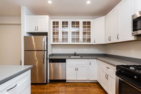 San Francisco apartment for rent - A kitchen with white cabinets and a stainless steel refrigerator.