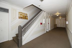 San Francisco apartment for rent - A hallway with a staircase and a painting on the wall.