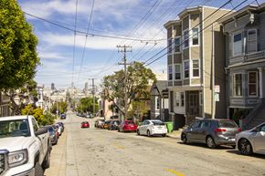 San Francisco apartment for rent - A street with cars parked on the side and buildings on the side.