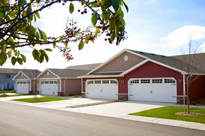 Kent apartment for rent - a red house with two garage doors and a driveway