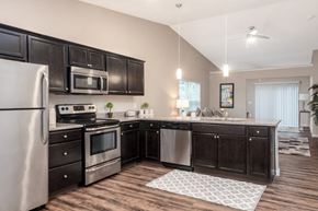 Kent apartment for rent - a kitchen with stainless steel appliances and black cabinets