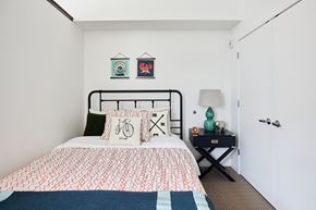 Minneapolis apartment for rent - a bedroom with a bed and two paintings on the wall