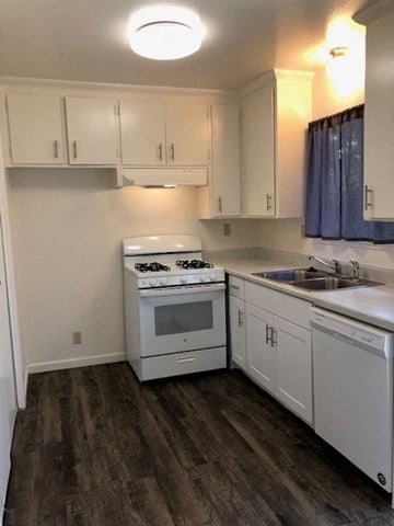 Modesto apartment for rent - a kitchen with white cabinets and a stove and a sink