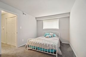 Baltimore apartment for rent - Neatly made bed with blue pillows