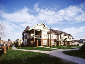 Rochester townhouse for rent - a row of houses with a sidewalk in front of them