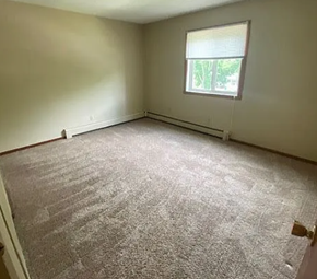 West Fargo apartment for rent - A room with a carpeted floor and a window.