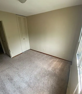 West Fargo apartment for rent - A room with a carpeted floor and a window on the right side.