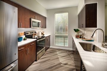 La Mesa apartment for rent - A modern kitchen with wooden cabinets and stainless steel appliances.