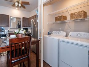 Bentonville apartment for rent - a kitchen with a washer and dryer and a dining table with a chair